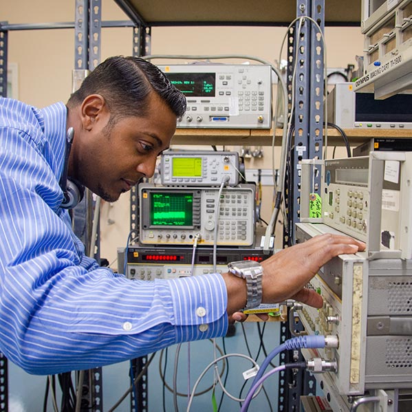 Alltest technician running a test with a signal generator and network analyzer
